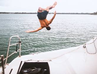 6 Factors to Consider When Chartering a Luxury Yacht for Your Next Holiday 1 A man diving in the sea for a swim