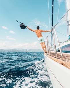 Things You Must Do on your Trip to Cabo 2 A man holdingblack backpack on a yacht charter