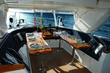 The Luxurious Fishing Fleets Available at Tag Cabo Sportfishing 2 the deck of a ship with brown dining tables