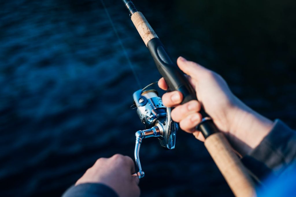 Don’t Let Aquaphobia Stop You from Enjoying Our Luxury Charters 2 A person holding a fishing rod in the deep sea.