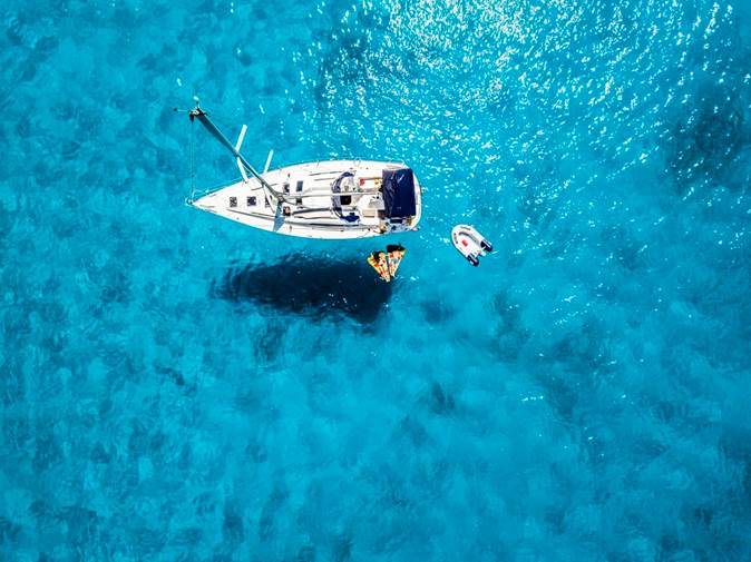 Boating Safety Tips 1 Boat floating on crystal blue water